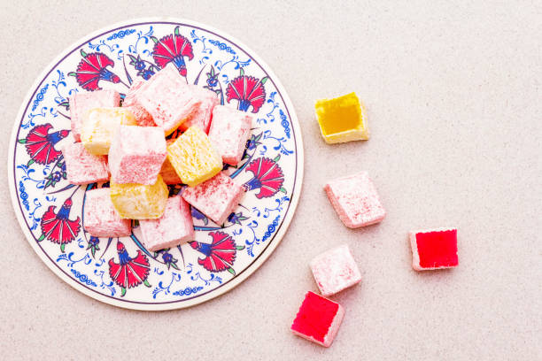 istock Eastern sweets. Traditional Turkish delight Rahat lukum with a rose on ceramics with typical folk patterns 1165692429