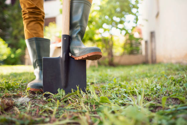 Ready for gardening Close-up shot of an unrecognizable gardener standing in his backyard with shovel pinned to the ground. rubber boot stock pictures, royalty-free photos & images