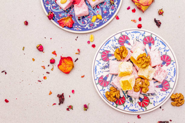 istock Eastern sweets. Traditional Turkish delight Rahat lukum with a rose on ceramics with typical folk patterns 1165693199