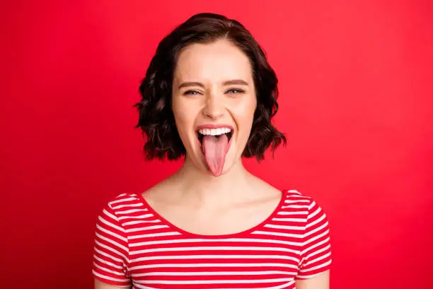 Photo of Closeup photo of fooling girlfriend teasing you through camera while isolated with red background