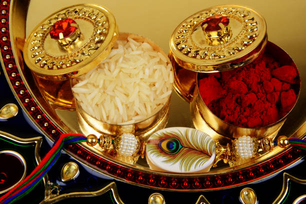 Raksah Bandhan or Rakhi, Indian festival for brothers and sisters Raksah Bandhan or Rakhi, Indian festival for brothers and sisters, on this festival sisters tie a bracelet on brothers wrist to ensure her security, and celebrate the festival by giving gifts and sweet to each other mirror work thali decoration stock pictures, royalty-free photos & images