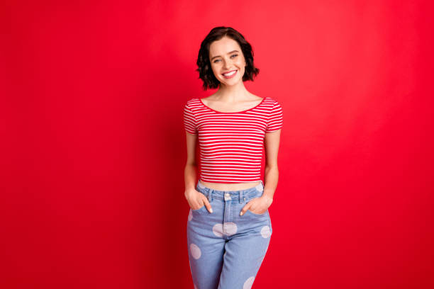 Photo of charming marvelous girlfriend standing casually carefully while isolated with red background