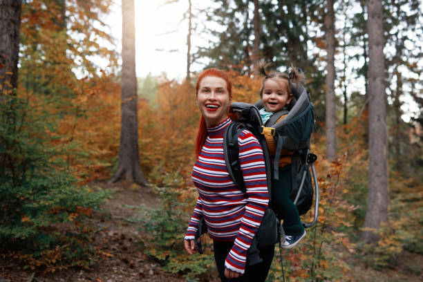 Supermom and her daughter hiking in the forest