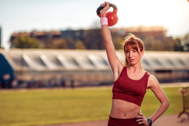 istock Woman training with kettlebell outside 1165696700