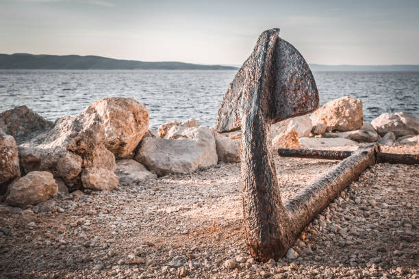 Anchor part submerged in shallow tropical waters