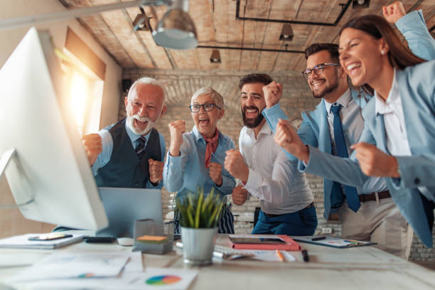 istock Business team celebrating a success with arms up 1165699993