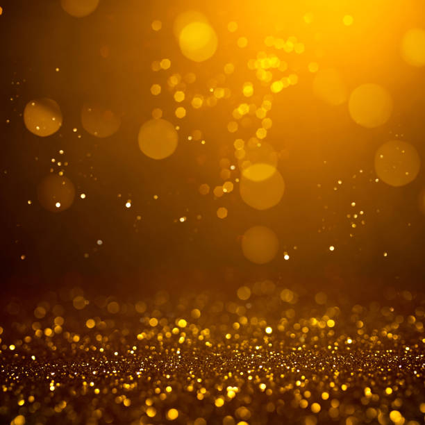 istock Golden abstract bokeh on black background. 1165700668