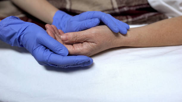 istock Nurse supporting and calming down patient before procedure caring hospital staff 1165701155