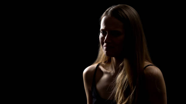 istock Sad woman crying, isolated on black background, upset with bad news, problems 1165702429