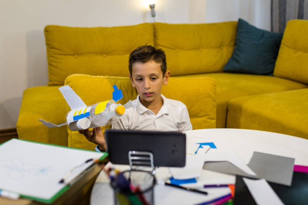 istock Happy Boy playing with a toy made from recycled paper and plastic 1165703127