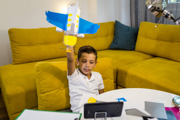 istock Happy Boy playing with a toy made from recycled paper and plastic 1165703241