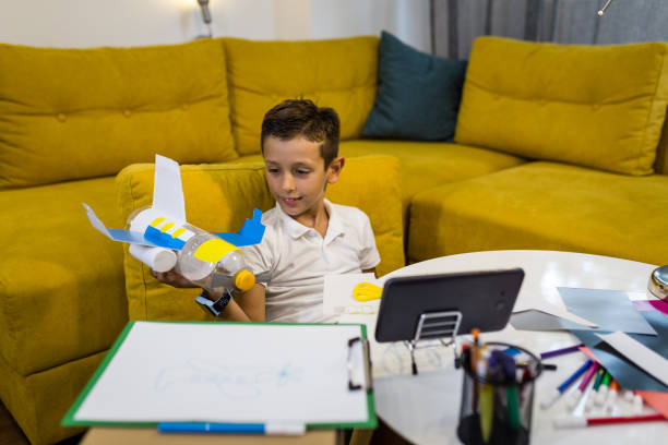 istock Happy Boy playing with a toy made from recycled paper and plastic 1165703962