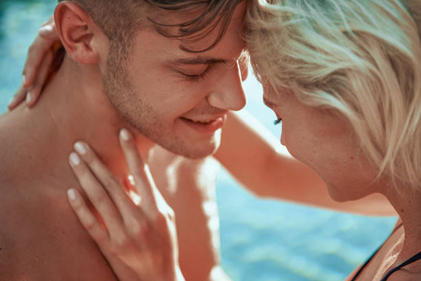 istock Young couple spending time together in swimming pool 1165704774