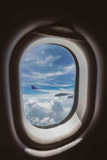 istock Cloudy blue sky from airplane window. 1165705623
