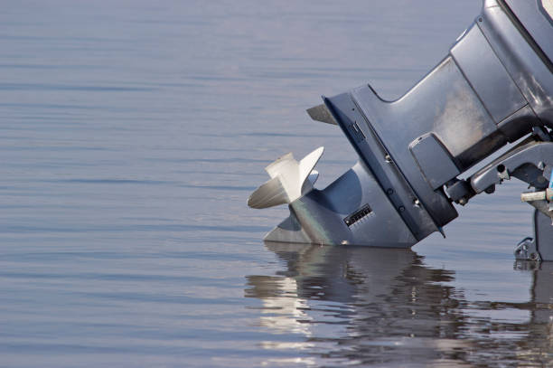 istock Outboard motor lowered into the water. A boat engine is waiting to be started. 1165705665