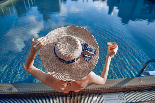 istock Young lady looking at the reflection on water 1165705669