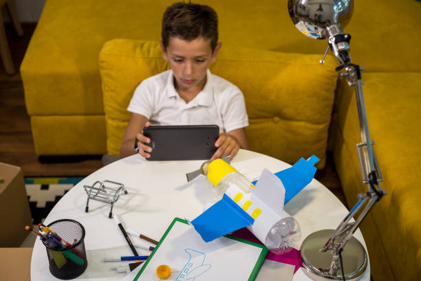 istock Learning from the internet how to make DIY toy from plastic and paper 1165705676