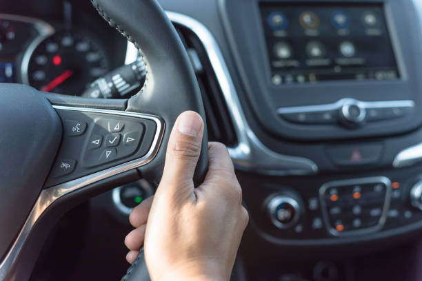 istock Asian man hand holding steering wheel with audio control and call buttons 1165706009