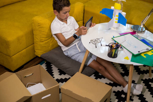 istock Learning from the internet how to make DIY toy from plastic and paper 1165707372