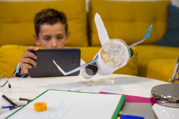 istock Learning from the internet how to make DIY toy from plastic and paper 1165707374