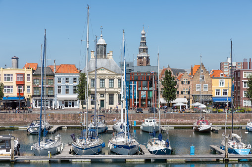 Vlissingen, The Netherlands - June 28, 2019: Historic inner harbor medieval Dutch city Vlissingen with yachts and restaurants