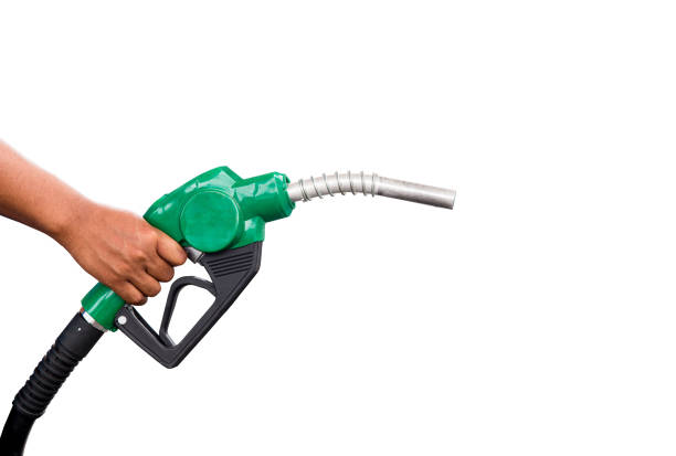 Hand holding gas nozzle with one last drop. A man holding a green gasoline nozzle on a white background. hands of men who were holding an automatic nozzle to make refill oil. Hand holding gas nozzle with one last drop. A man holding a green gasoline nozzle on a white background. hands of men who were holding an automatic nozzle to make refill oil. fuel pump photos stock pictures, royalty-free photos & images