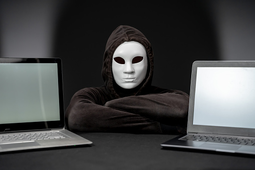 Hacker Computer Security Camera Computer Hacker Looking At Camera Between Two Laptops Stock Photo ...