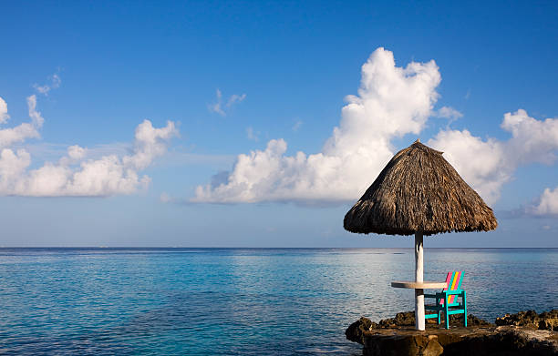 A colorful chair in the morning sun overlooking the Caribbean Sea.