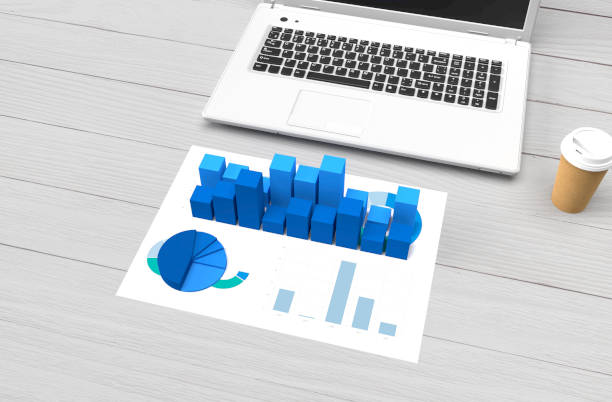 istock Wooden desk with technology and financial figures. 1165713501