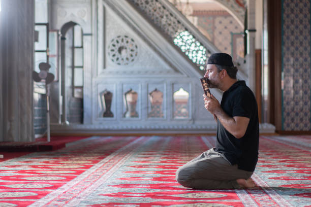 istock Muslim men holding koran in mosque 1165714429