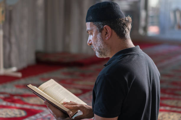 istock Muslim man reading koran in mosque 1165715006