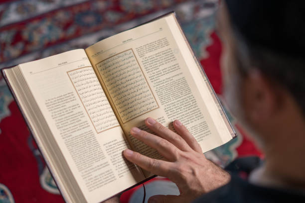 istock Muslim man reading koran in mosque 1165715681