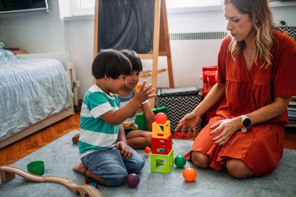 istock Cute Boys Playing With Wooden Toy Train 1165716557