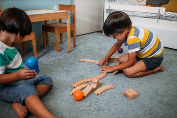istock Cute Boys Playing With Wooden Toy Train 1165717125