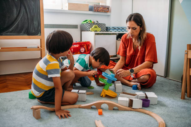 istock Cute Boys Playing With Wooden Toy Train 1165717158