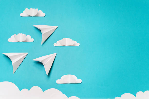 istock 3 origami planes and paper cut sky with clouds. Craft objects for banners/landing pages/backgrounds design with copy space. 1165717576