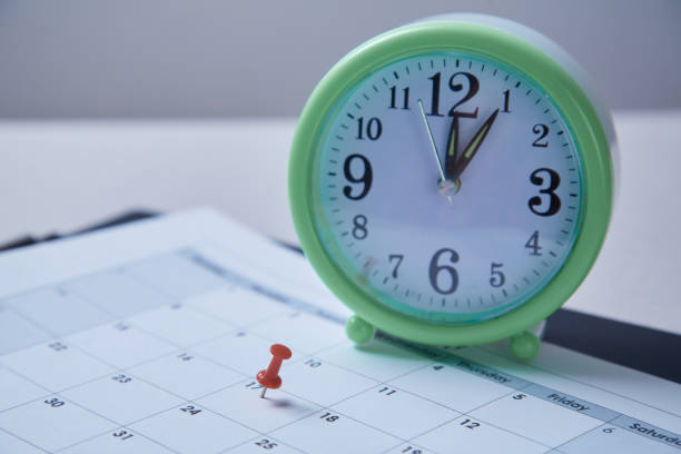 istock Time management, deadline and schedule concept: alarm clock and pushpin on schedule plan 1165721509