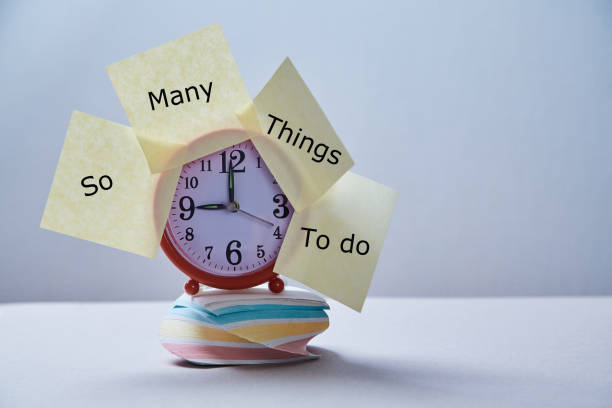 istock Time management deadline and schedule concept: clock with stickers on the stack of stickers 1165721517