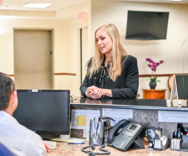 istock woman at a reception desk, waiting room or ofice 1165722218