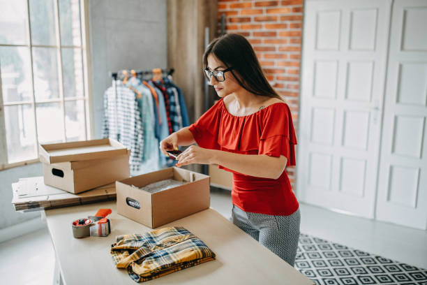 Young woman packing goods for shipment