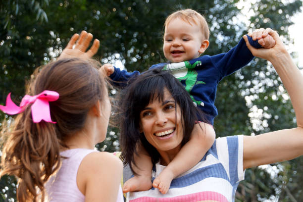 istock mother and children strolling outdoors 1165727614