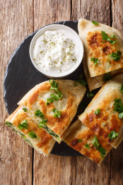 istock Afghan fried flat breads with potatoes, green onions and cilantro closeup. Vertical top view 1165729642