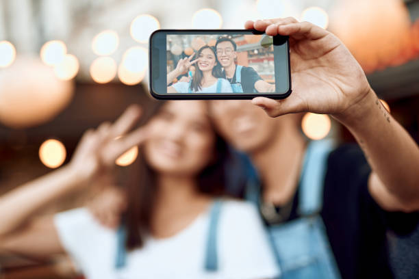 istock Happy asian couple making selfie on phone 1165729744