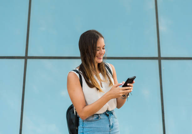 istock Young woman is using her smartphone, there is a mirror behind her 1165729823