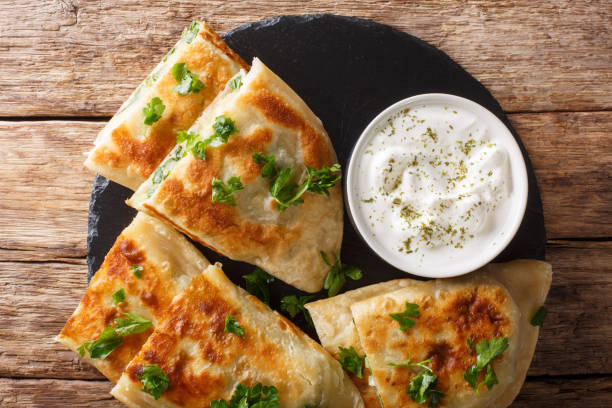istock Afghan fried flat breads with potatoes, green onions and cilantro closeup. horizontal top view 1165730776