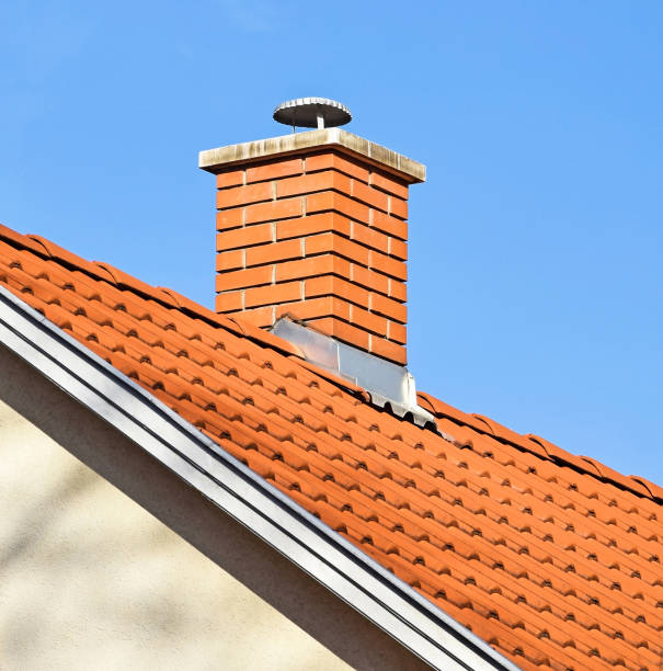 istock Smoke stack on the roof of a house 1165730966