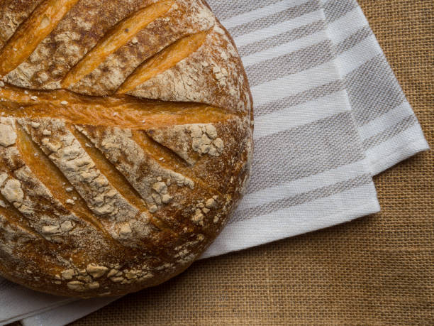 Freshly baked traditional bread with beautiful pattern, on wooden table