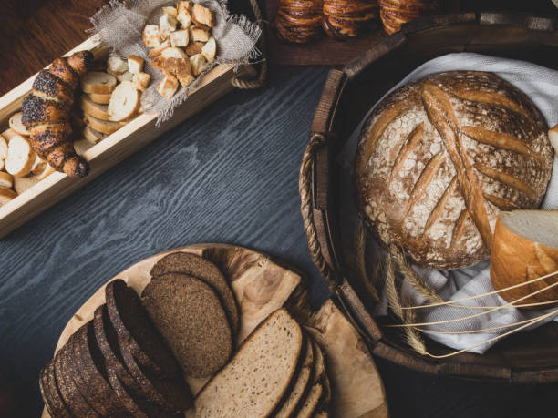 istock Several types of fresh bread lying on an wooden table 1165731866