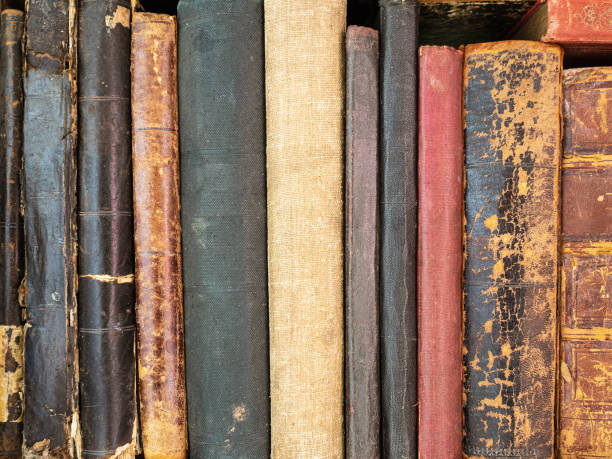 istock Historically valuable books. Very old and torn books on the shelf 1165733387
