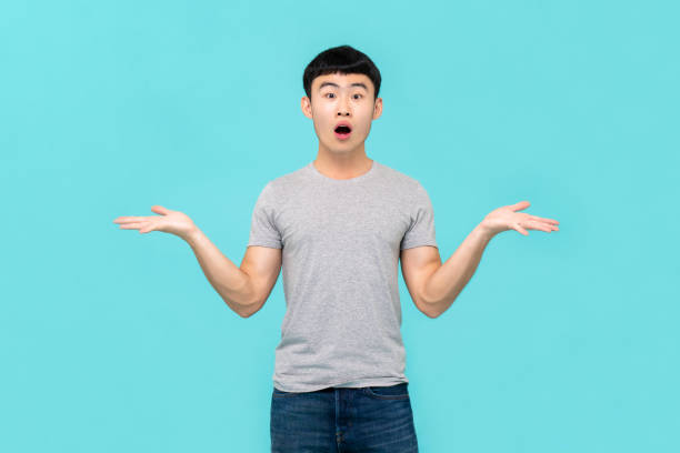 shocked young asian man being doubtful - humor asking nerd men imagens e fotografias de stock